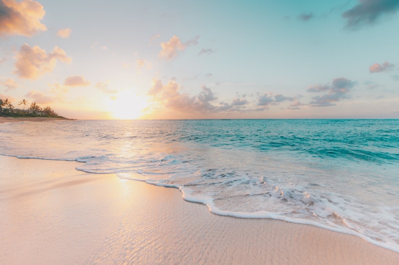 Location Beach at sunrise with waves running up the sand