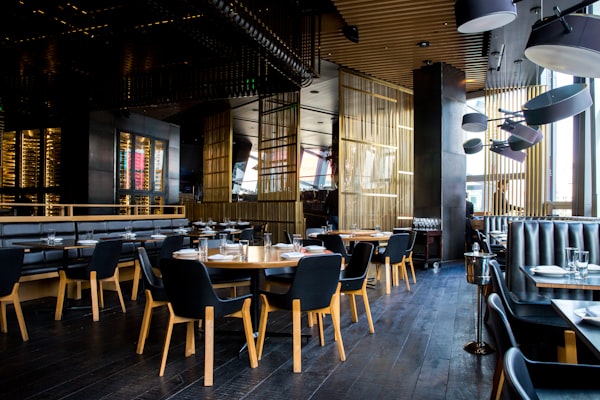 Location Interior of a modern restaurant with round tables and low lighting