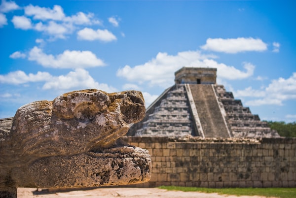 Location The pyramid at Chichén Itzá with a carved stone serpent head in front