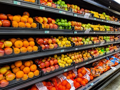 Reviews Shelves of fruit with oranges, apples and limes