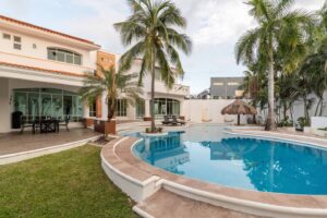 Spaces The back of the villa and the pool seen from the lawn, with the palapa on the right